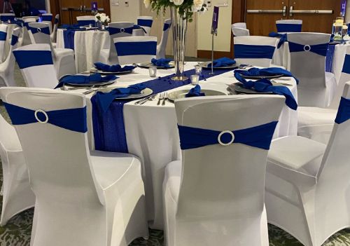 Wedding reception room with white-draped tables and chairs